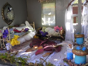 The sitting room, with a hand-sewn couch, art, and acorn stools...